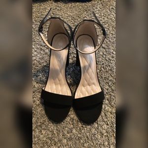 A classic two-strap sandal with a block heel and side buckle closure.